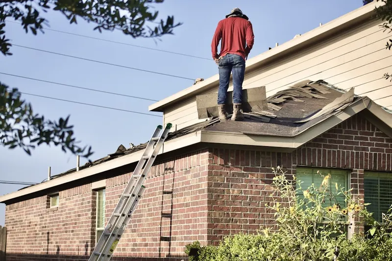 Professional roofer working on a residential roof in Bertrand